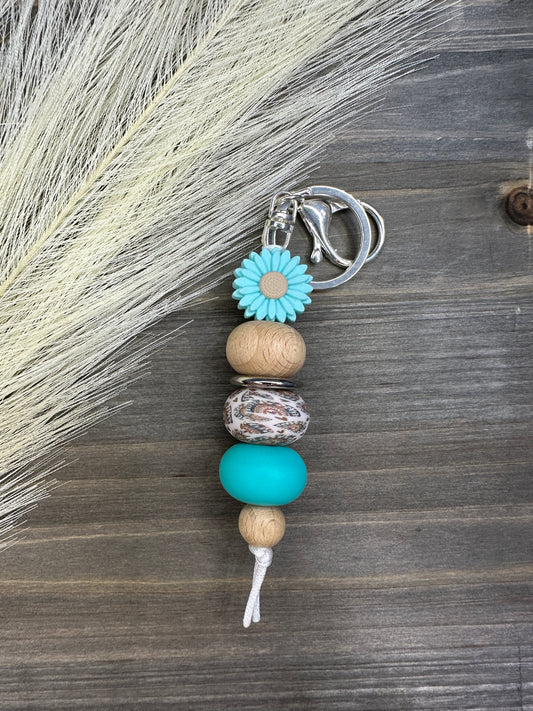 Teal daisy rainbow keychain